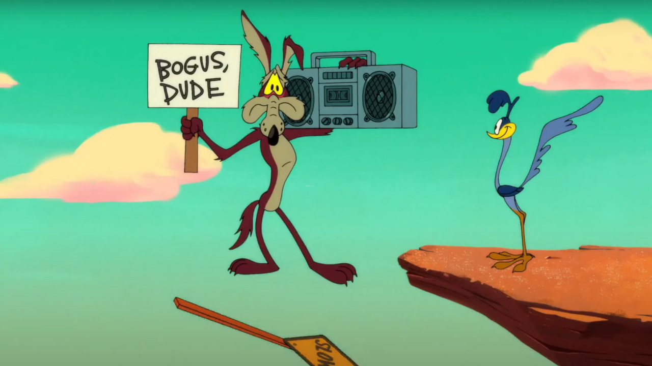 Wile E. Coyote sur le point de chuter, tout en tenant une pancarte et une boombox,